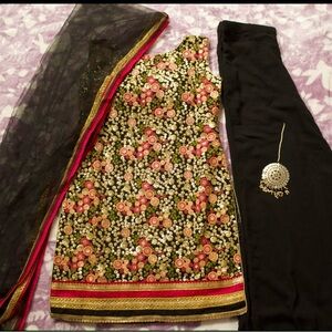 It’s black color plazo suit with net duppata and with beautiful tikka